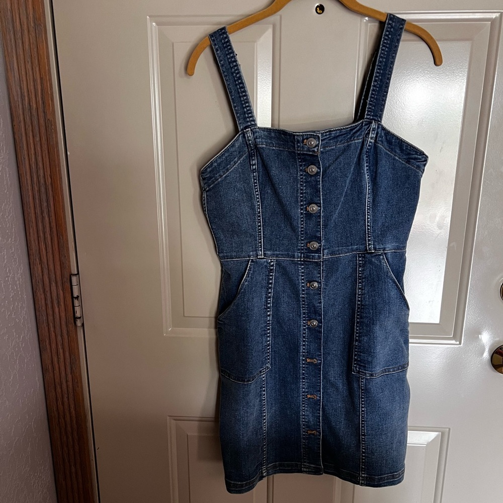 Super cute jean mini dress with adjustable straps in the perfect jean color.